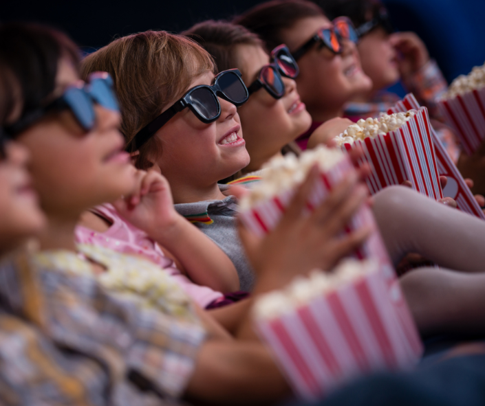 kids eating popcorn in cinema kids eating popcorn in cinema